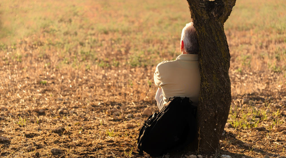 thinking against a tree