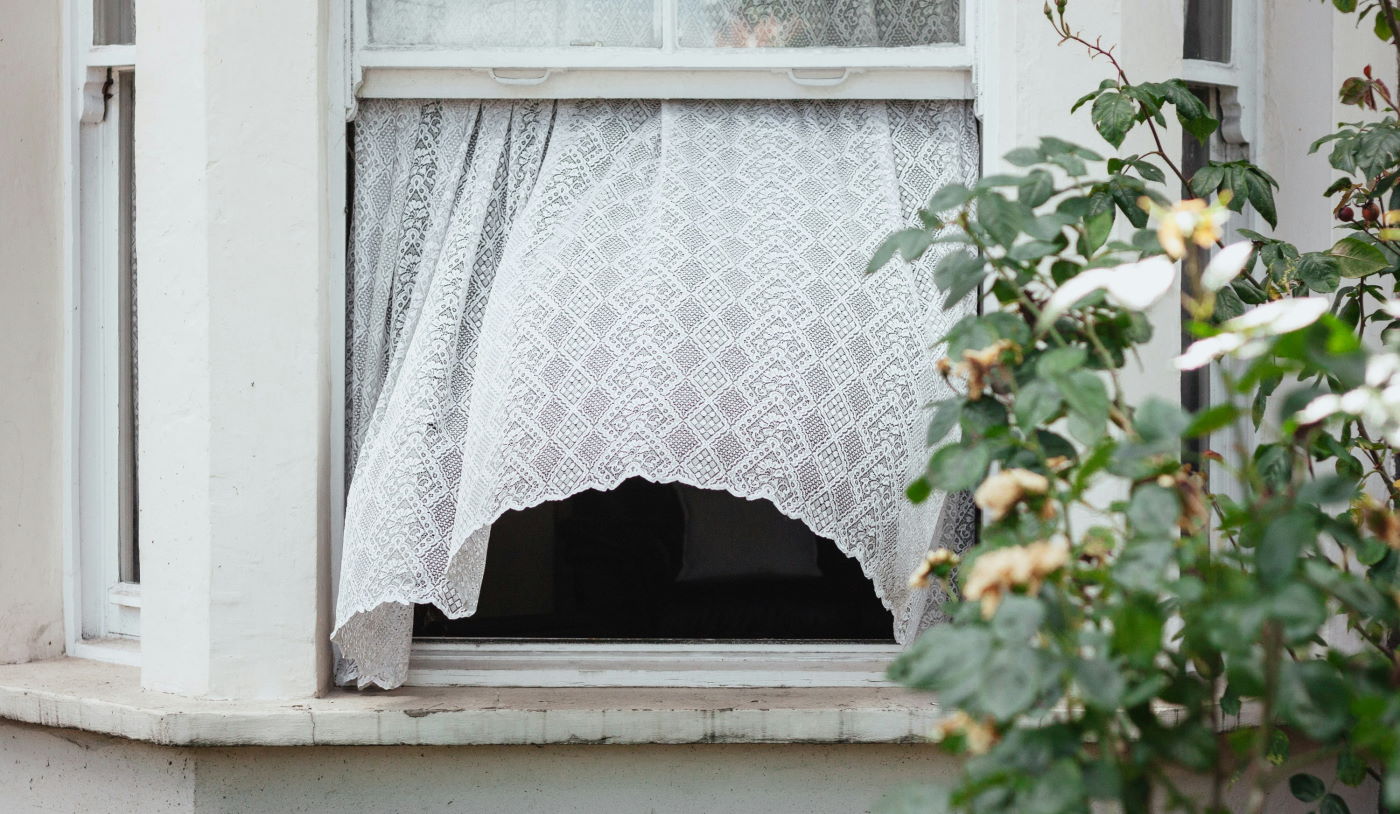 window open with curtain blowing